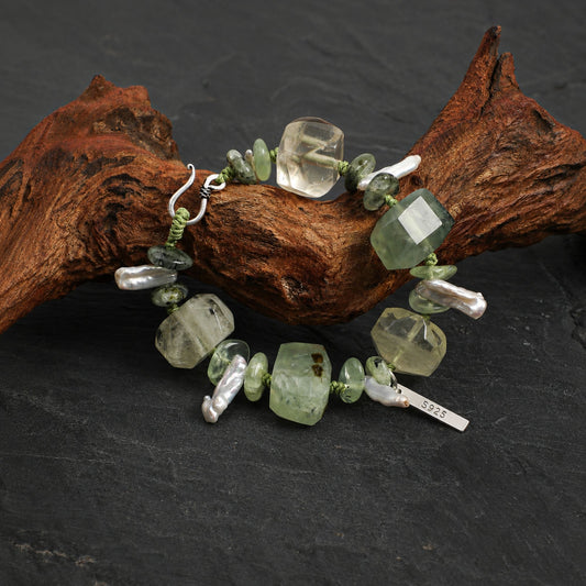 Multi-stone bracelet featuring green prehnite, clear crystals, and white freshwater pearls