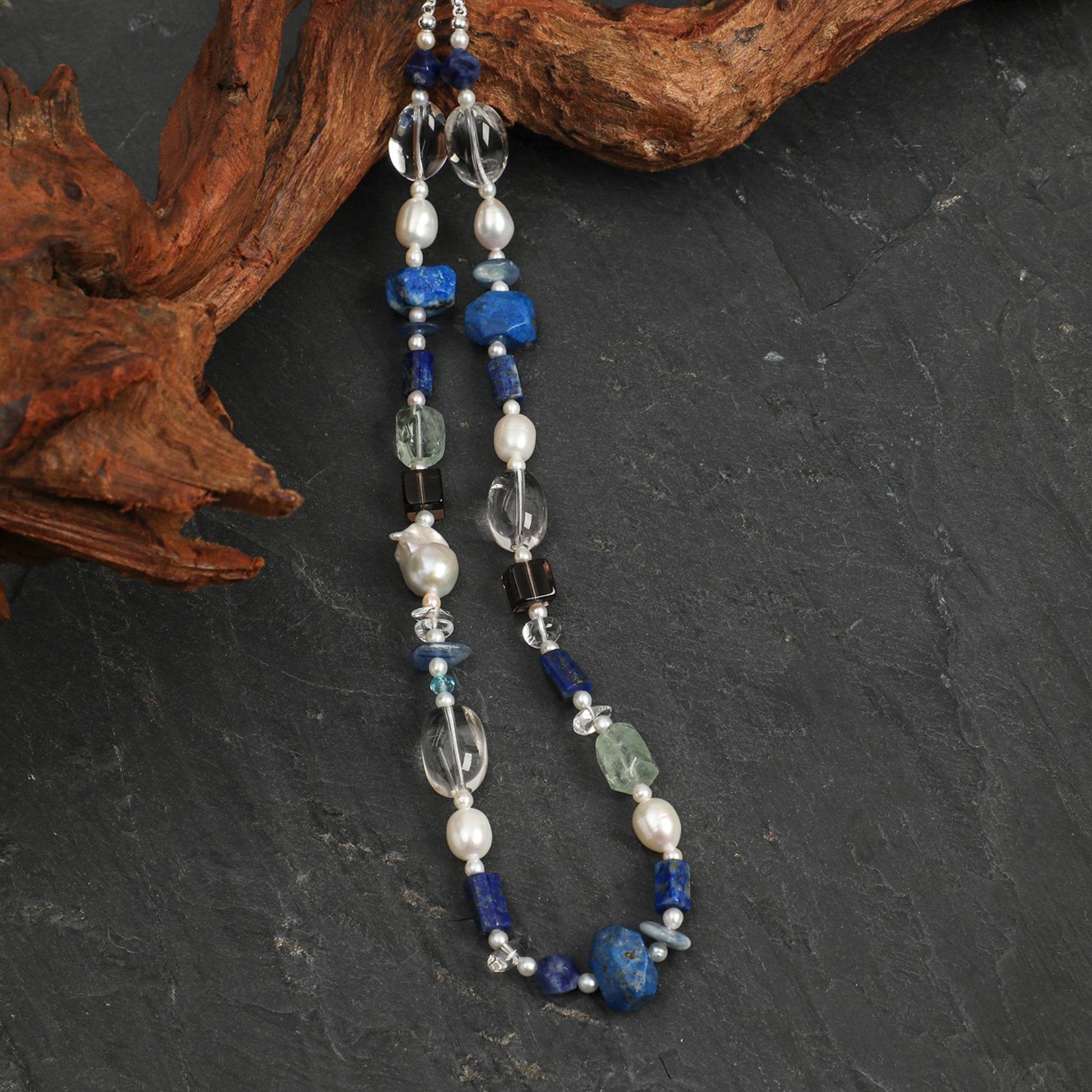 Lapis lazuli necklace with long drop charms: blue and clear stones with pearl beads