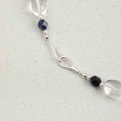 Lapis lazuli necklace clasp detail: blue bead segment with crystal and pearl accents