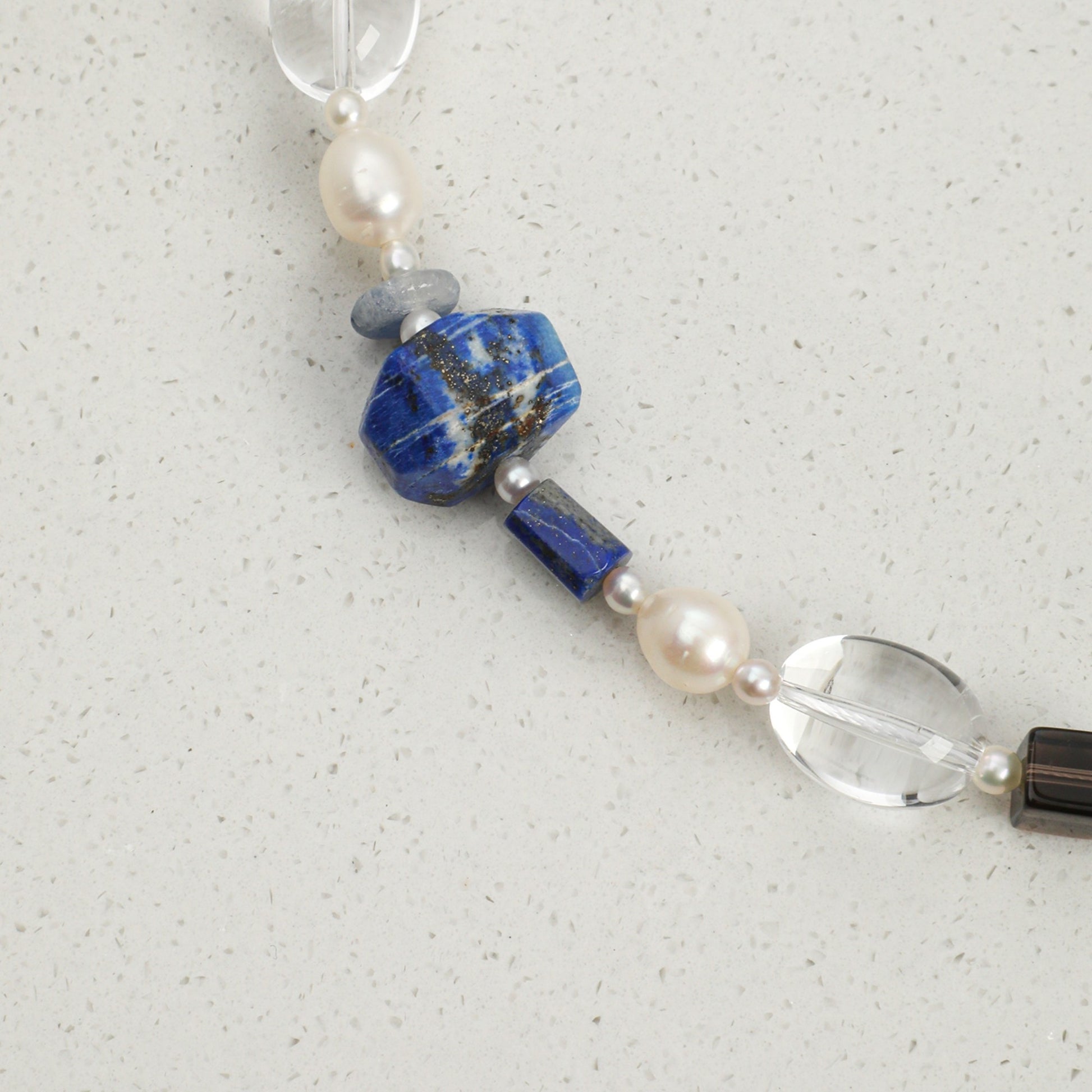 Lapis lazuli necklace detail: blue lapis and pearl beads with clear crystal and silver clasp