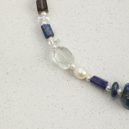 Lapis lazuli necklace detail: blue and pearl beads with clear faceted crystal and clasp
