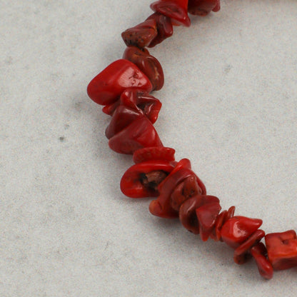 Red bead bracelet segment with glossy chip beads and curved links
