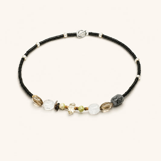 Black cord crystal and pearl necklace with grey, white, and gold-tone beads and toggle clasp