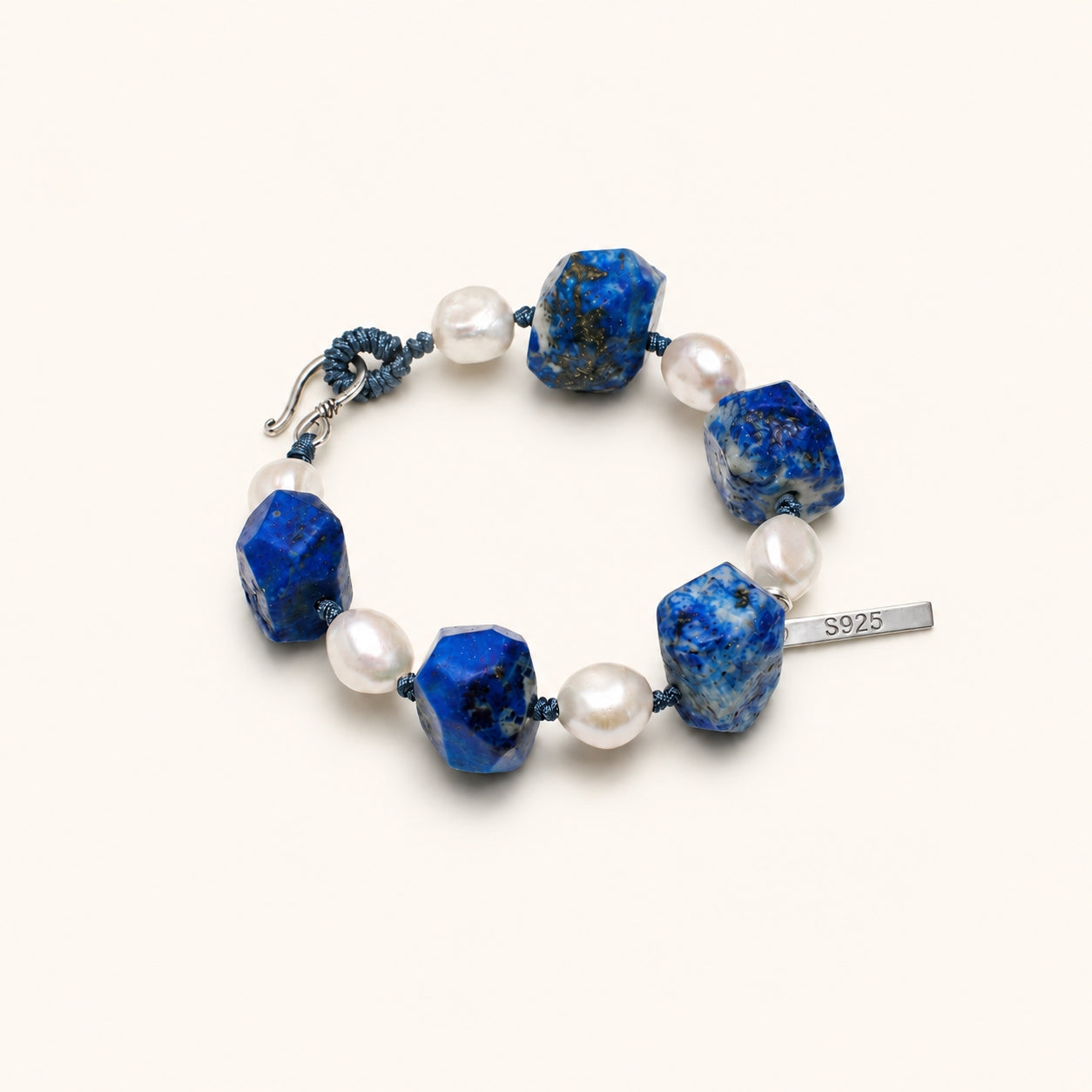 Lapis lazuli beaded bracelet with white pearls, blue macrame cord, and S925 tag