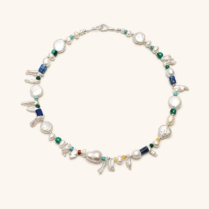Pearl and gemstone baroque necklace with silver clasp, green beads, and blue lapis accents