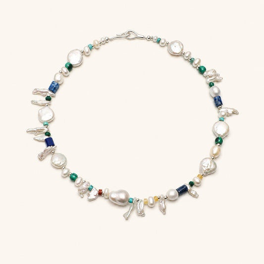 Pearl and gemstone baroque necklace with silver clasp, green beads, and blue lapis accents