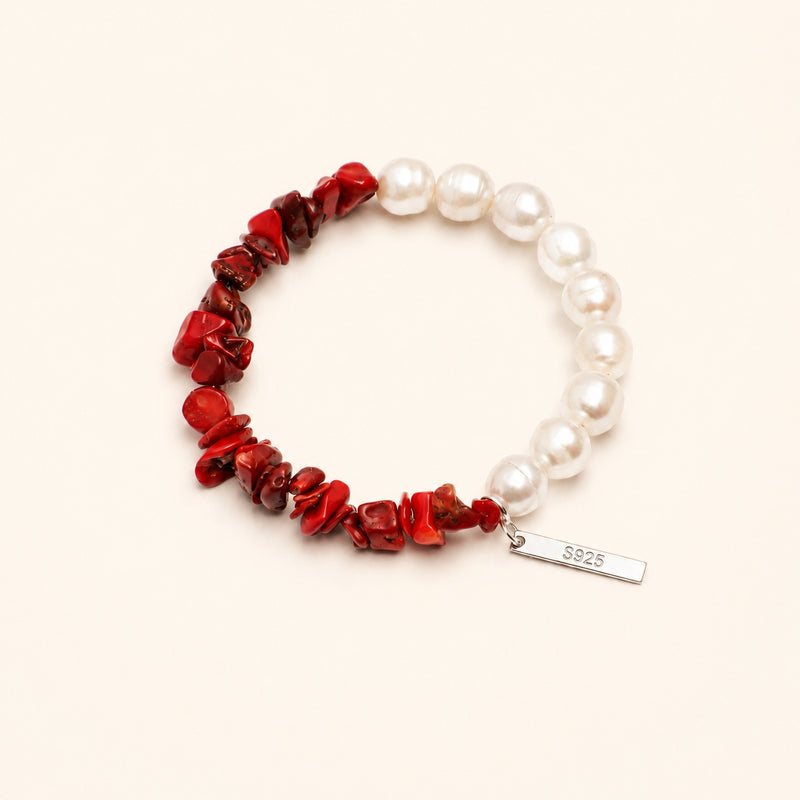 Pearl and red bead bracelet with S925 charm tag, looped on display