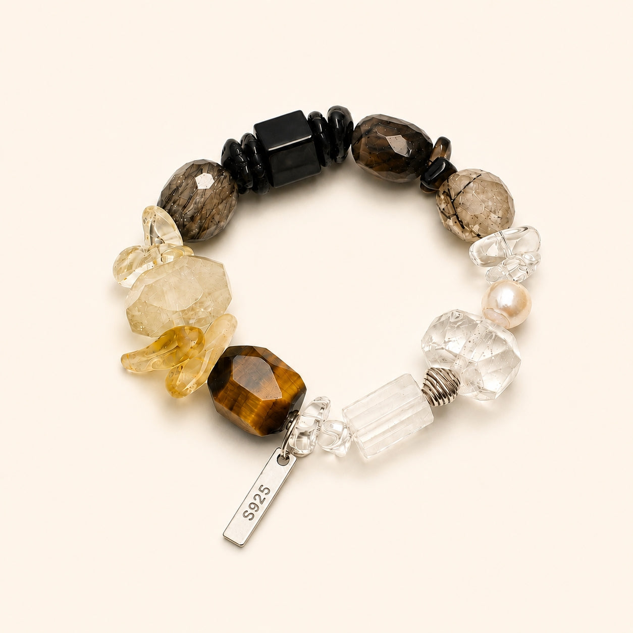 Beaded crystal and pearl bracelet with black accents, clear crystals, golden stones, and pearl