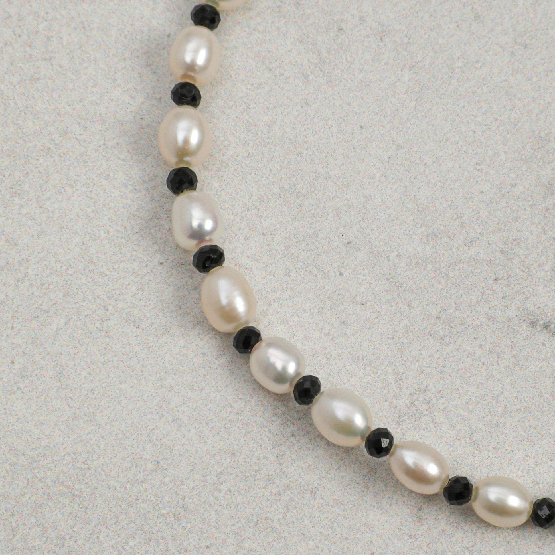 Pearl beaded bracelet with black spacer beads and silver accents