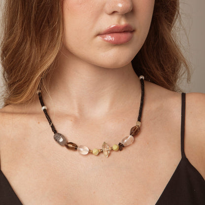 Model wearing black cord crystal necklace with clear, smoky grey and pearl-like bead details