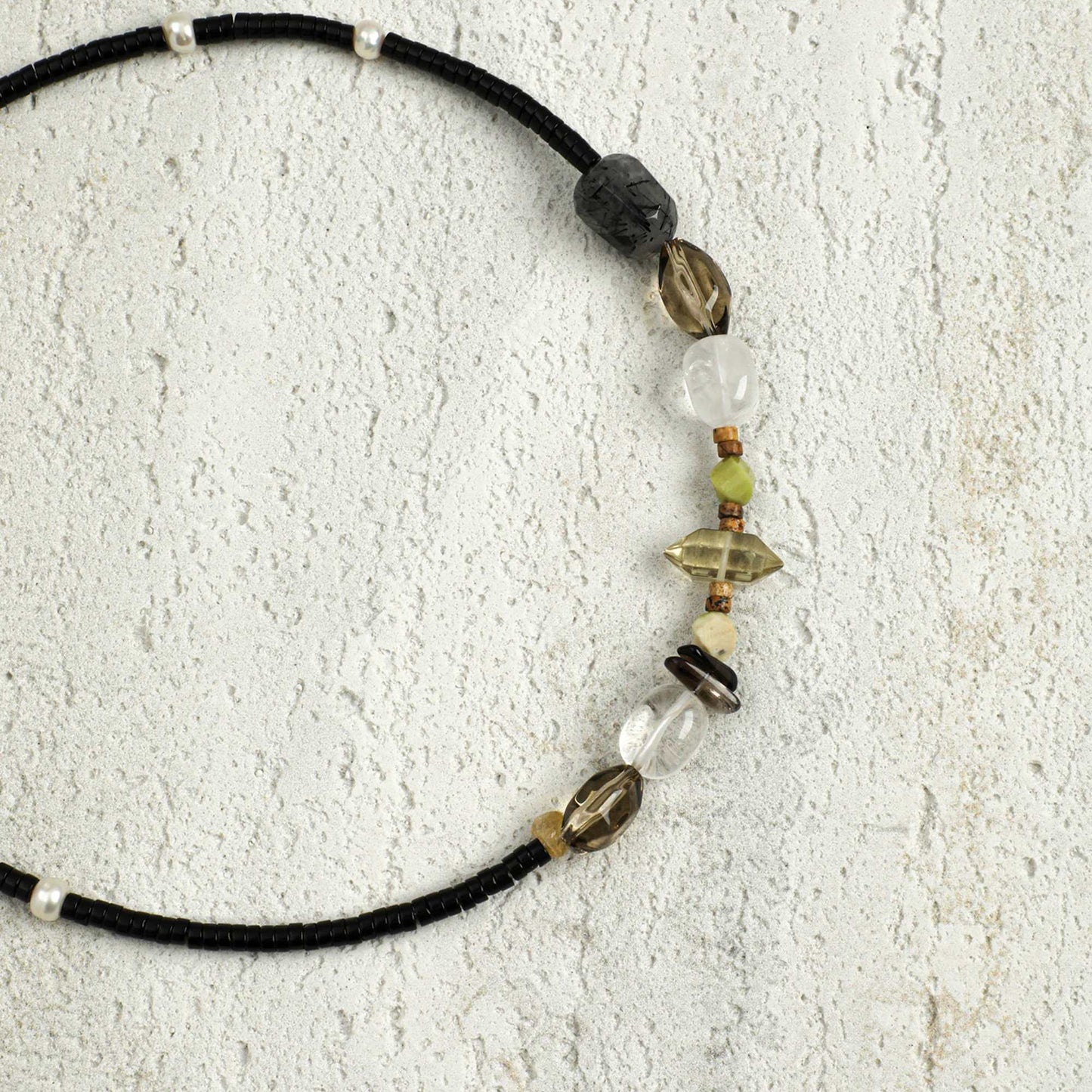 Black cord necklace with smoky grey, white crystal and gold-tone beaded charms