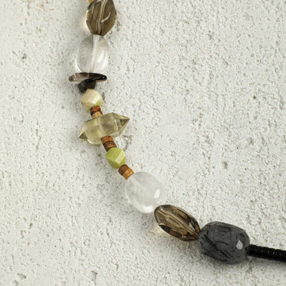 Black cord crystal necklace with white teardrop, gold star bead and green accent stones