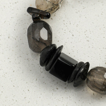 Crystal and pearl bracelet featuring dark gray stone beads and black spacer beads