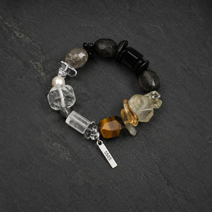 Crystal and pearl bracelet with black beads, tiger-eye style beads, clear crystals, and pearl
