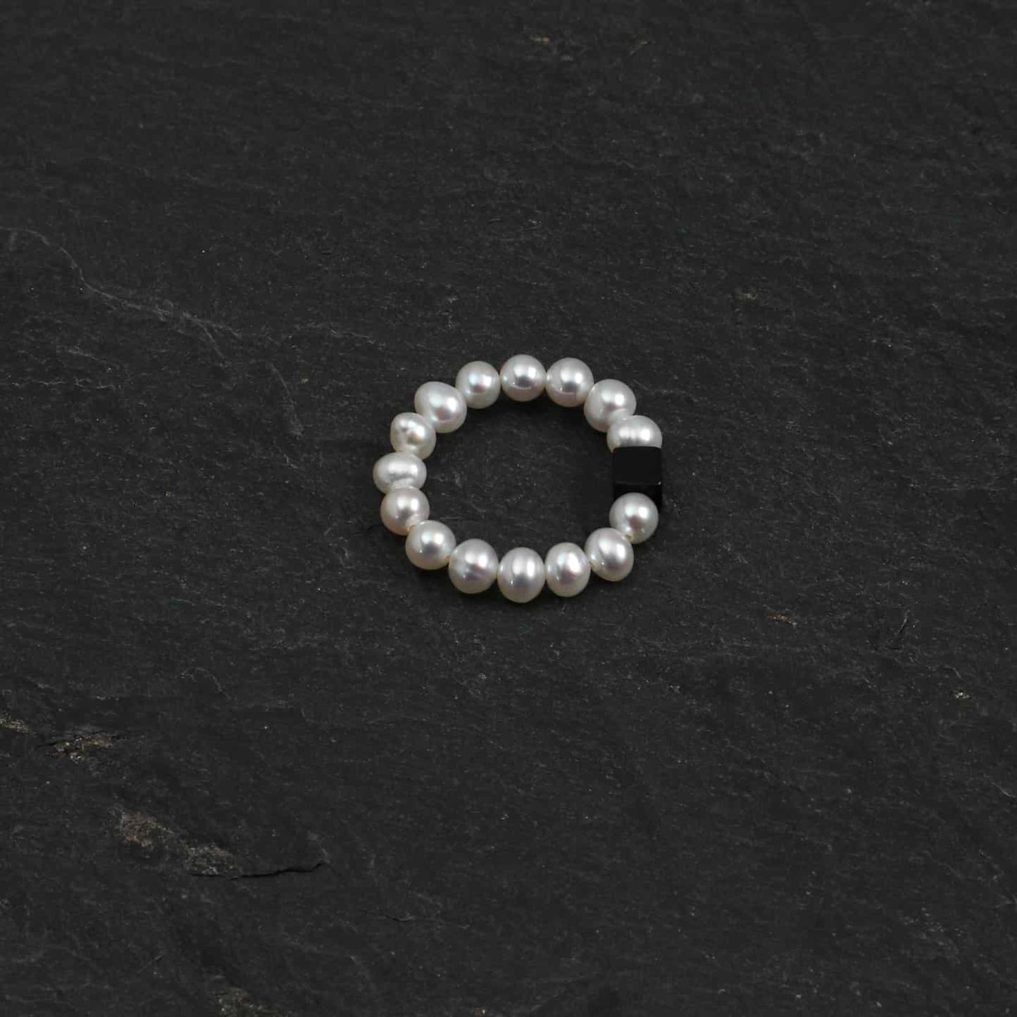 Pearl bead ring with dark rectangular gemstone accent, round beaded band
