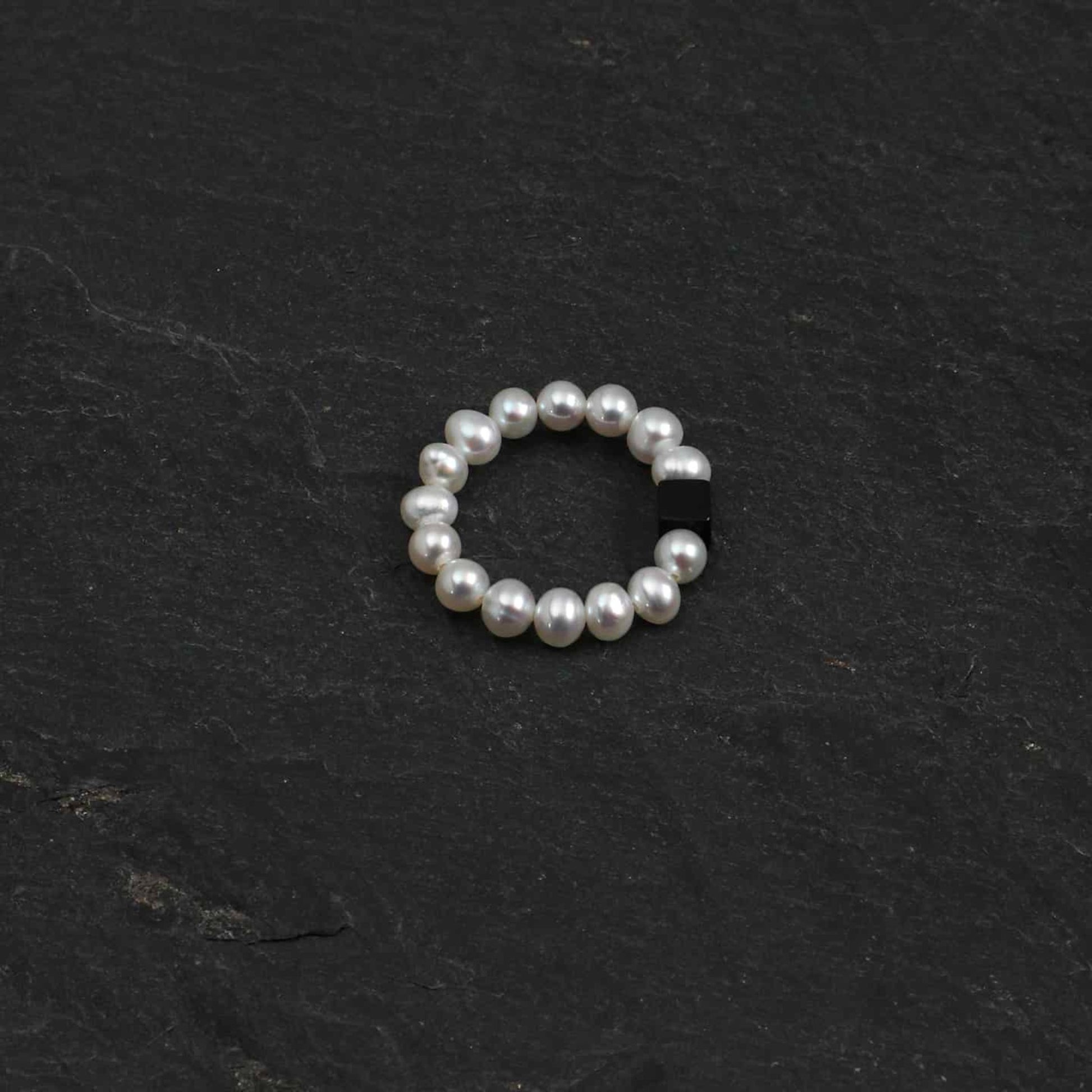 Pearl bead ring with dark rectangular gemstone accent, round beaded band