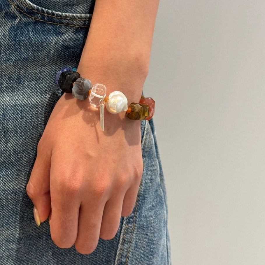 Multicolor gemstone bead bracelet with round silver pearl on wrist