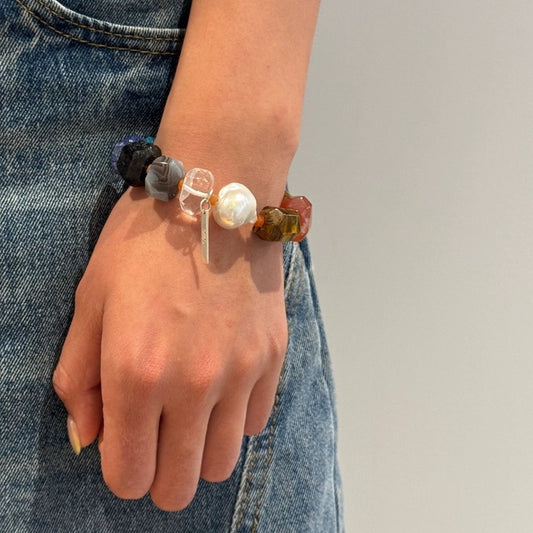 Multicolor gemstone bead bracelet with round silver pearl on wrist