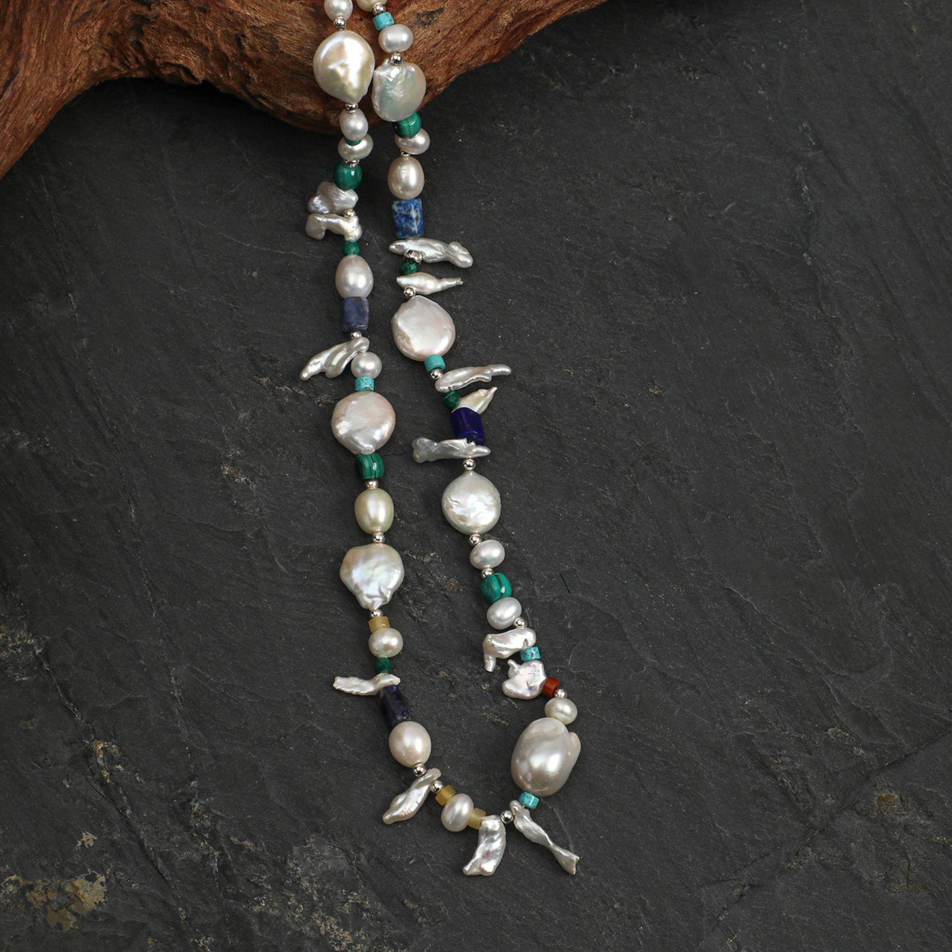 Layered pearl and gemstone necklace strand with long baroque pendants and bird charms