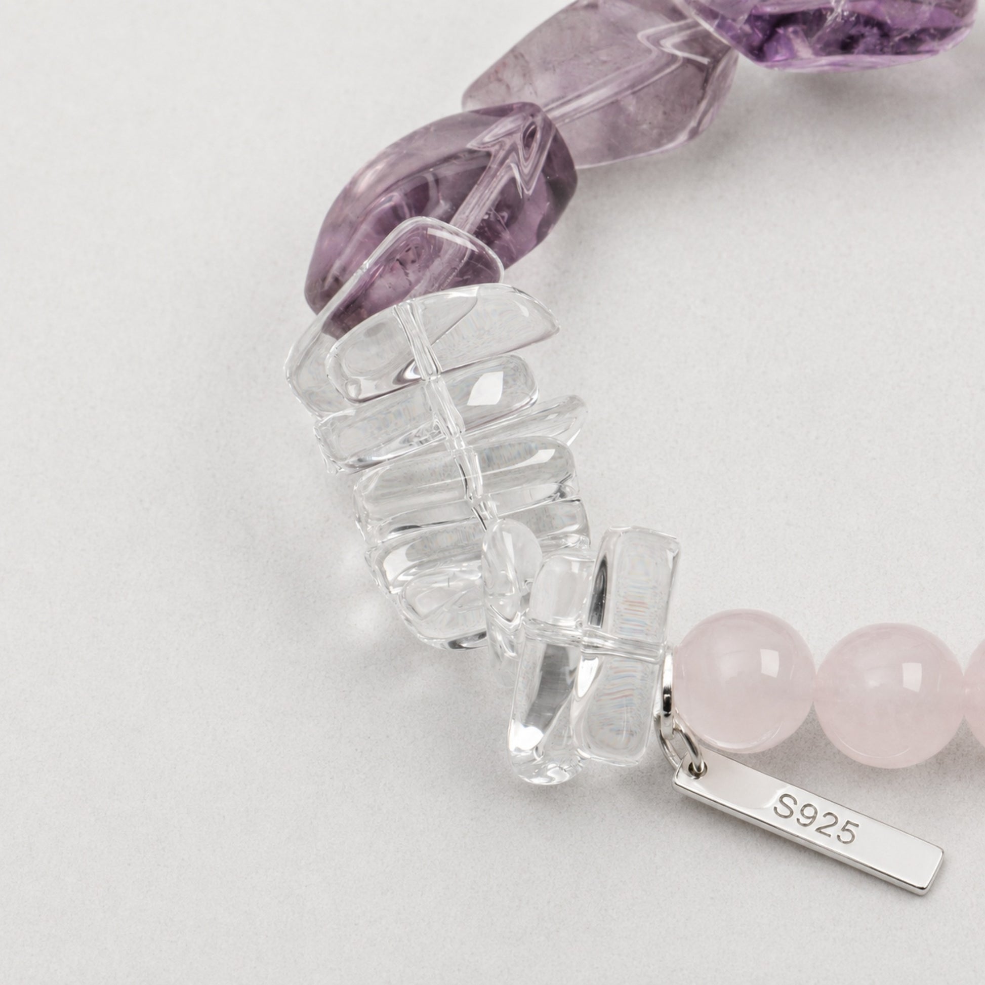 Amethyst and clear quartz bracelet detail with rose quartz beads and silver clasp