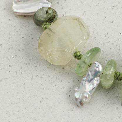 Citrine and prehnite bracelet close-up with white pearls, green beads, and silver accents